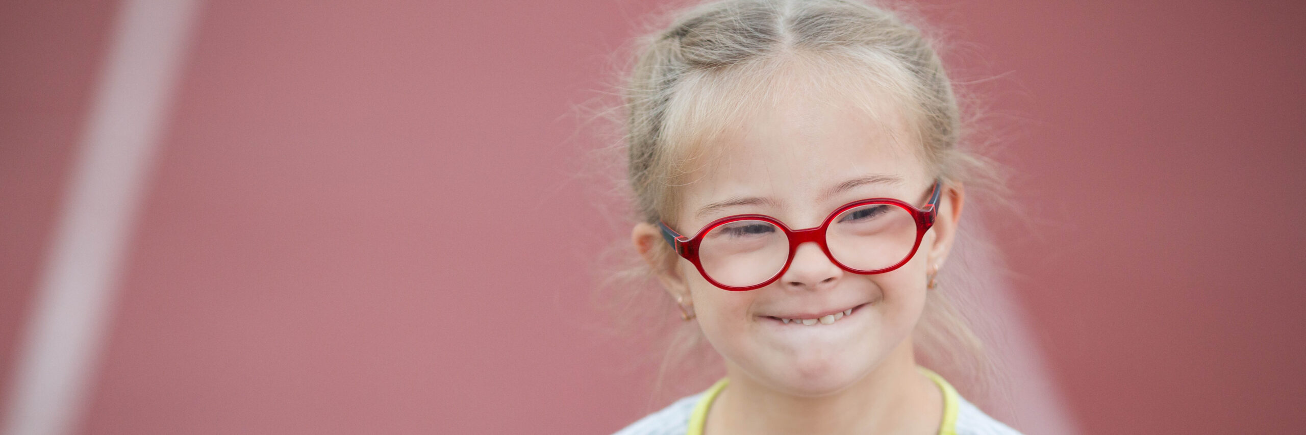A little girl with red glasses