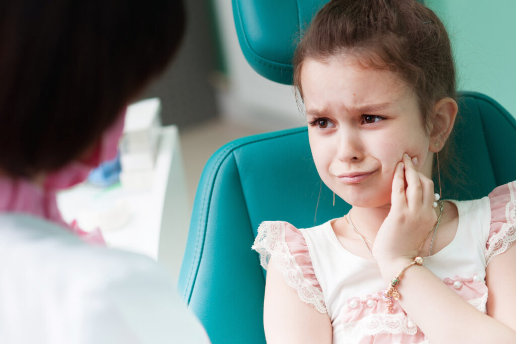 Young girl with tooth pain