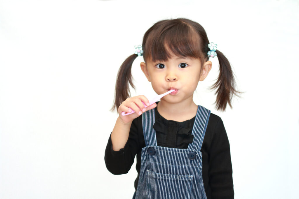 A little girl brushing her teeth