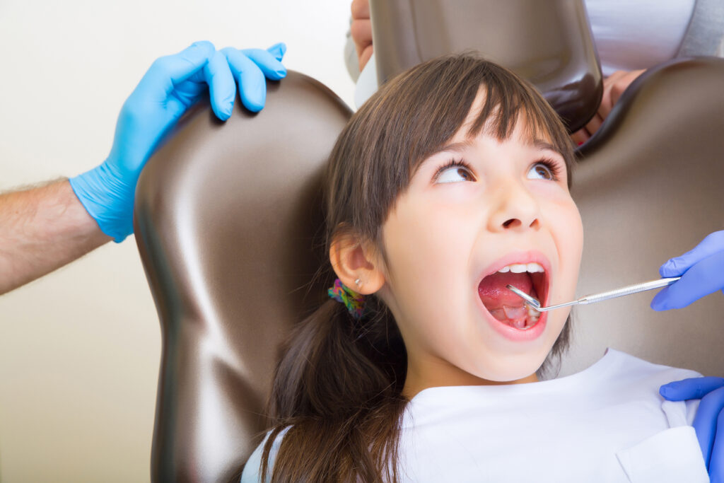 Girl sitting in dentist chair 