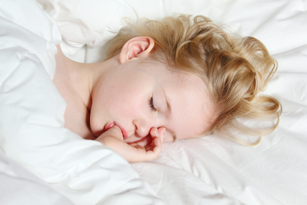 Kid sucking their thumb while sleeping