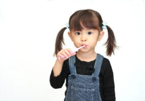 A little girl brushing her teeth